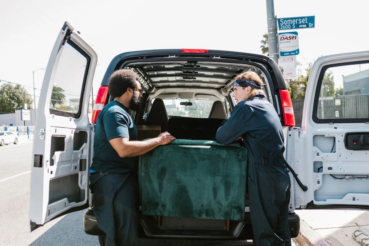 Movers loading furniture into a moving truck