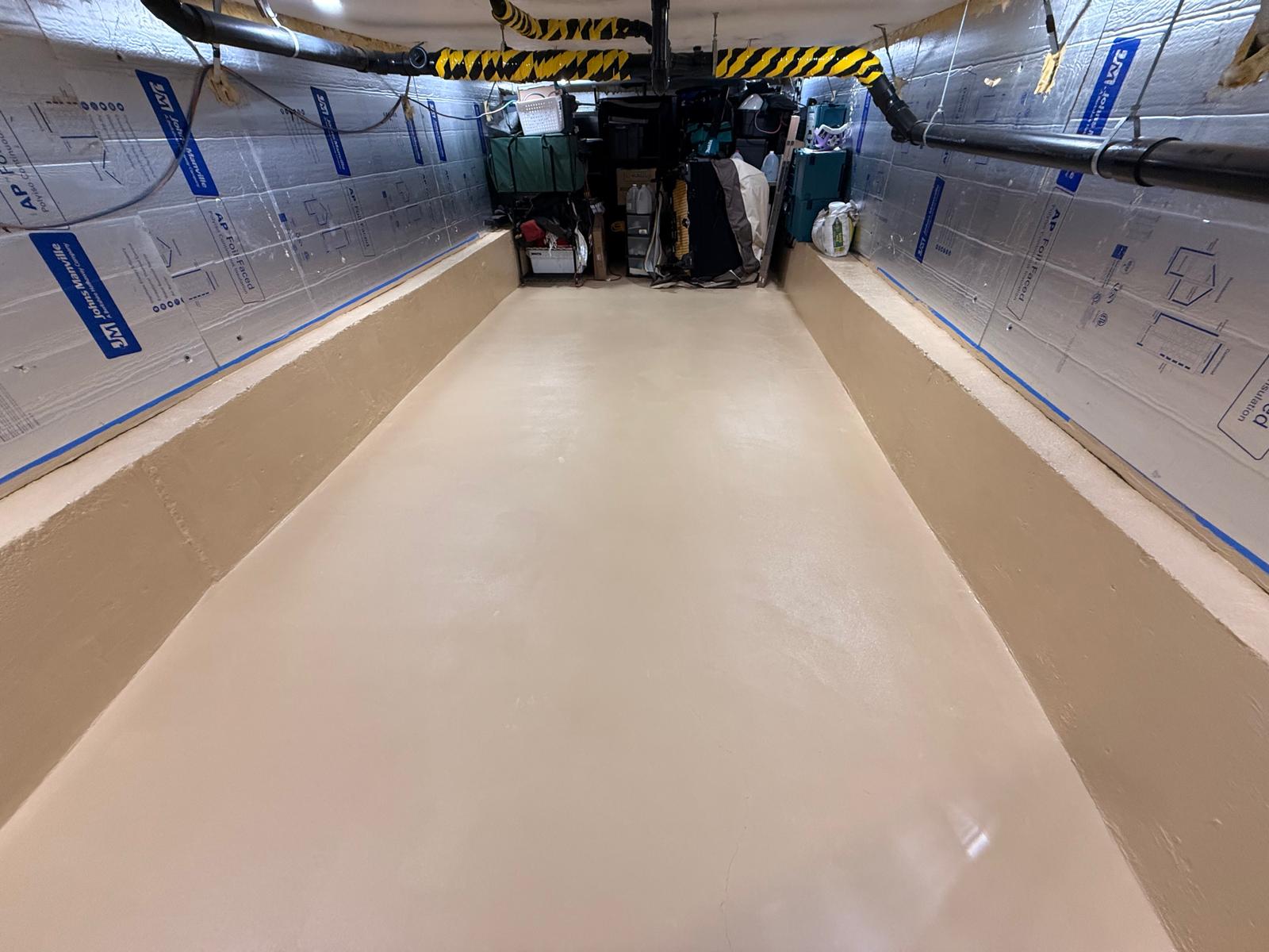 Basement interior with wall insulation and prepared concrete floor