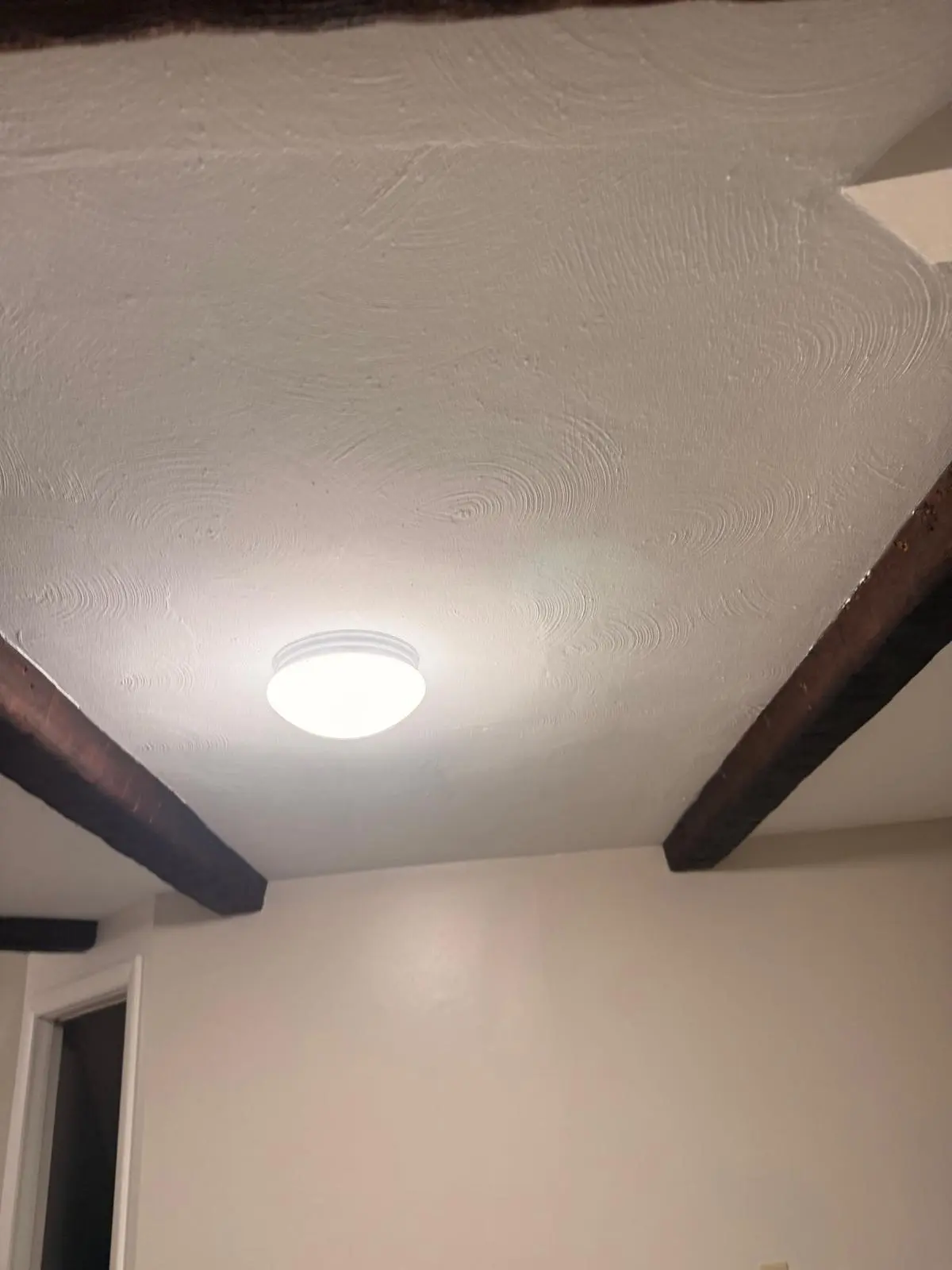 Freshly painted ceiling with exposed beams