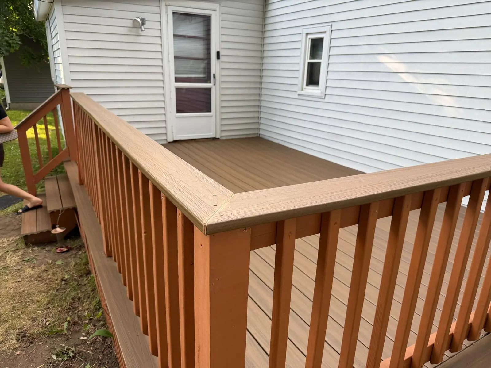 Completed deck surface and wood railing