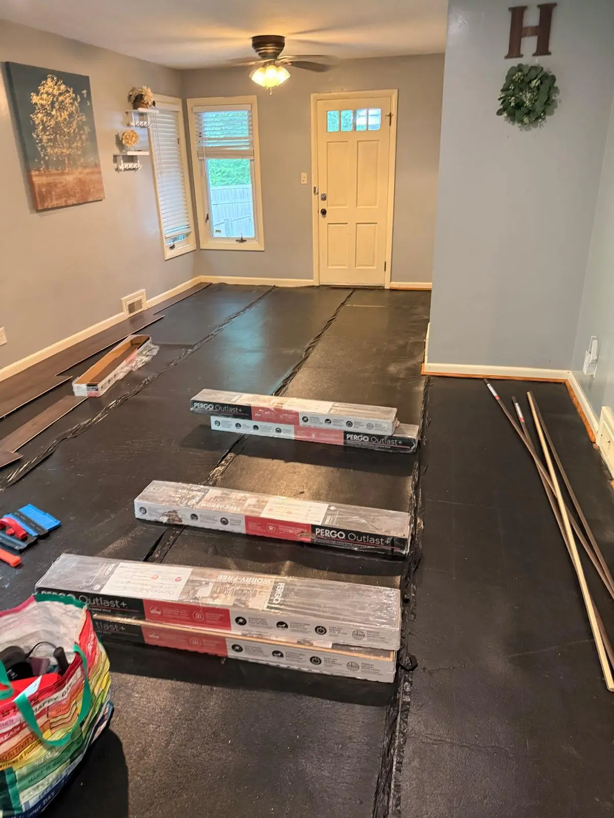Vinyl plank flooring materials staged for installation