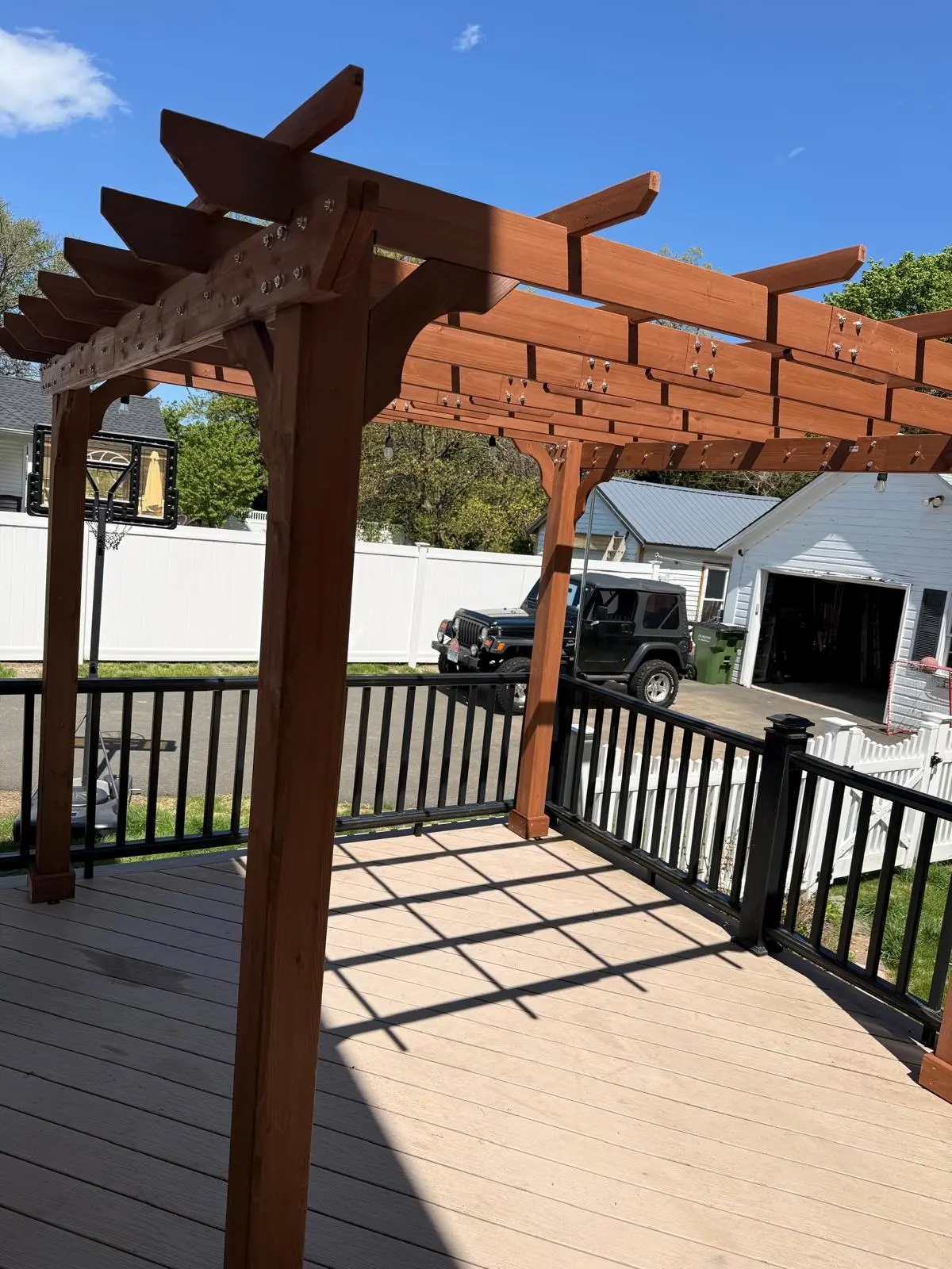 Wood pergola installed above a residential deck